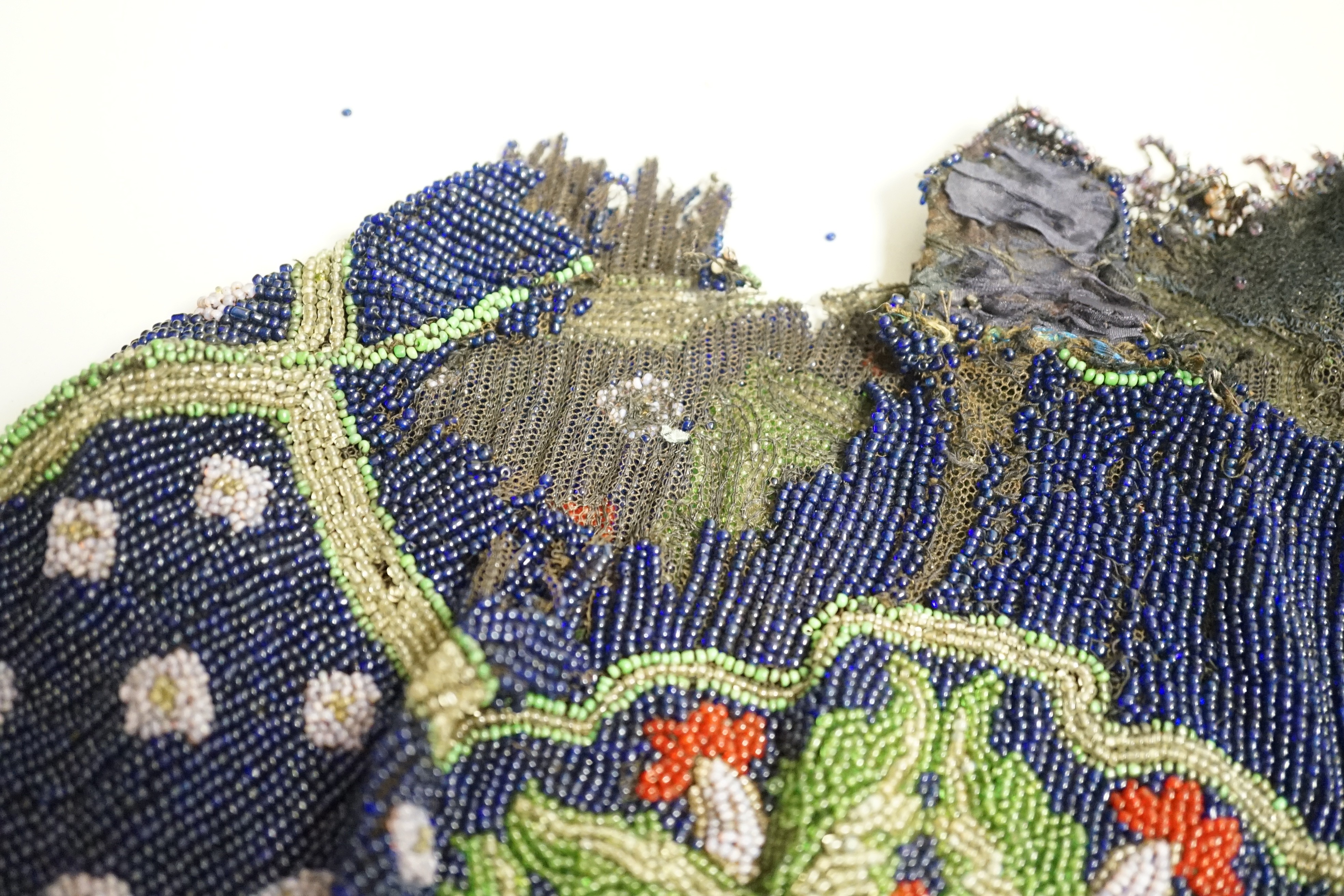 A velvet and metal embroidered reticule possibly 18th century, together with a collection of beaded embroidered knitted and leather purses, bags misers purses and a feather coin purse(14)